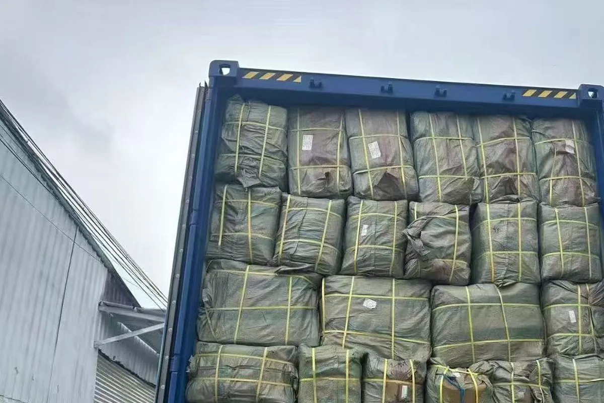 Container being loaded with cartons of custom backpacks for an export order